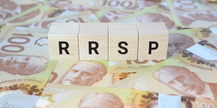 RRSP (Registered Retirement Savings Plan) on wooden blocks and Canadian one hundred dollar bills.