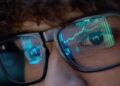 a person watches stock market trades