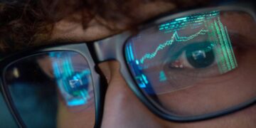 a person watches stock market trades