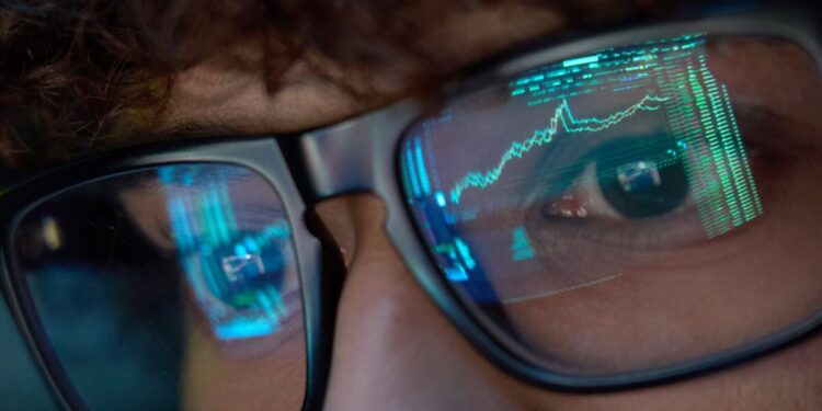 a person watches stock market trades