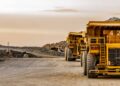 Super sized rock trucks take a load of platinum rich rock into the crusher.