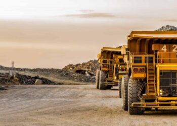 Super sized rock trucks take a load of platinum rich rock into the crusher.
