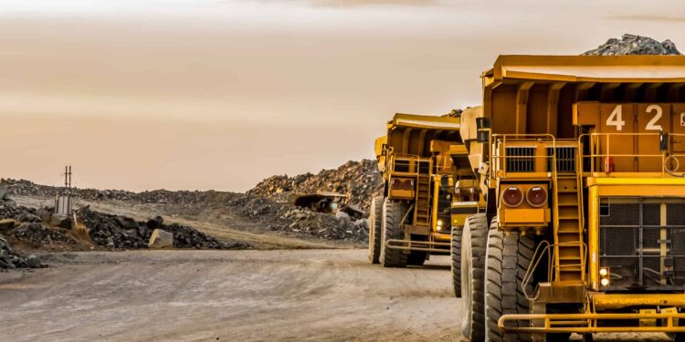 Super sized rock trucks take a load of platinum rich rock into the crusher.