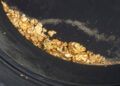 panning for gold uncovers nuggets and flakes