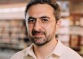 Photo of Microsoft AI CEO Mustafa Suleyman as he warns that Anthropic risks AI alignment failures by training Claude to view itself as a conscious entity deserving of legal rights.
