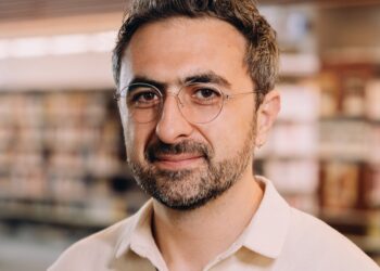 Photo of Microsoft AI CEO Mustafa Suleyman as he warns that Anthropic risks AI alignment failures by training Claude to view itself as a conscious entity deserving of legal rights.