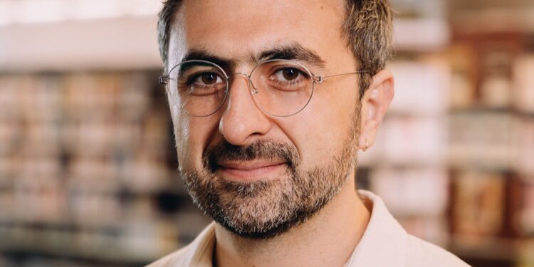 Photo of Microsoft AI CEO Mustafa Suleyman as he warns that Anthropic risks AI alignment failures by training Claude to view itself as a conscious entity deserving of legal rights.