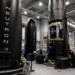 Rocket Lab engineers work around Neutron rocket hardware inside a large assembly facility.