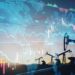 financial chart graphs and oil pumps on a field