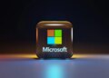 A glossy glass cube with the Microsoft logo on a dark surface