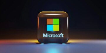 A glossy glass cube with the Microsoft logo on a dark surface