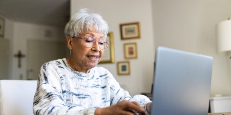 Senior uses a laptop computer