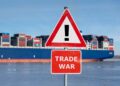 Warning sign with the text "Trade war" in front of container ship