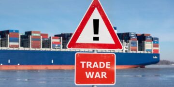 Warning sign with the text "Trade war" in front of container ship